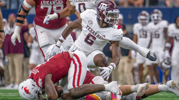 Razorbacks quarterback on ground again in game with Texas A&M after sack by Enai White
